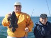 Joey with a nice sea bass as John is all smiles.